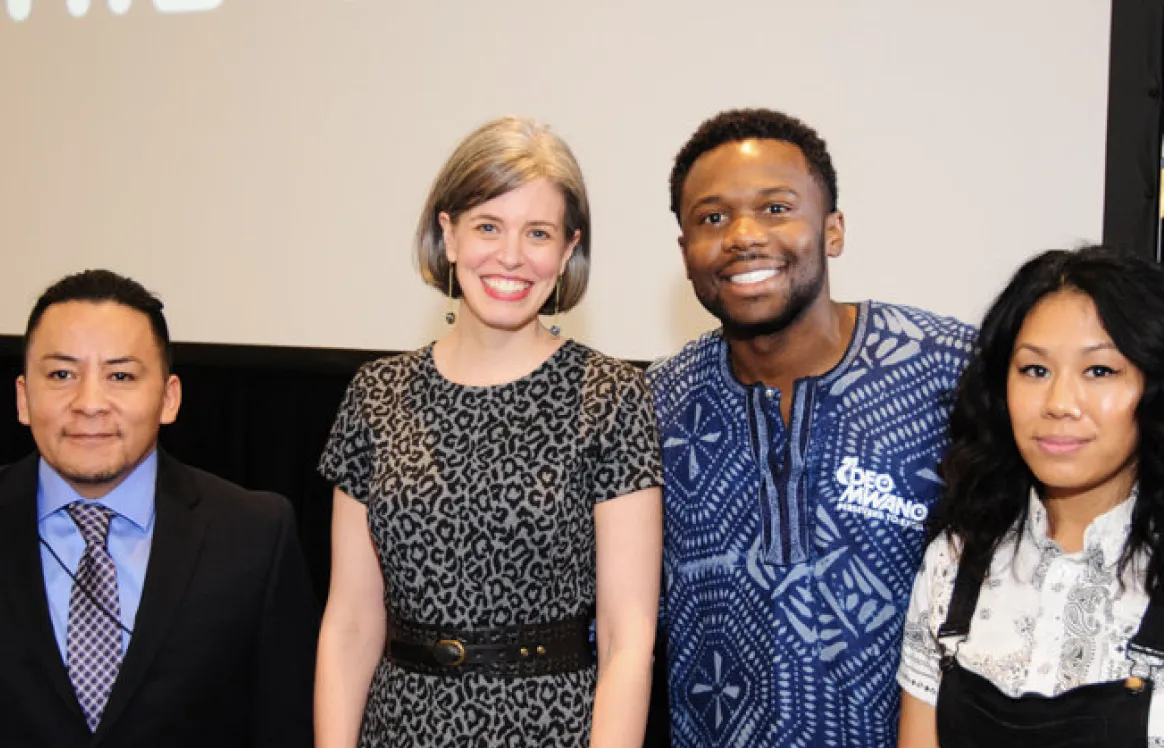 Deo Mwano with fellow panelists at a community event